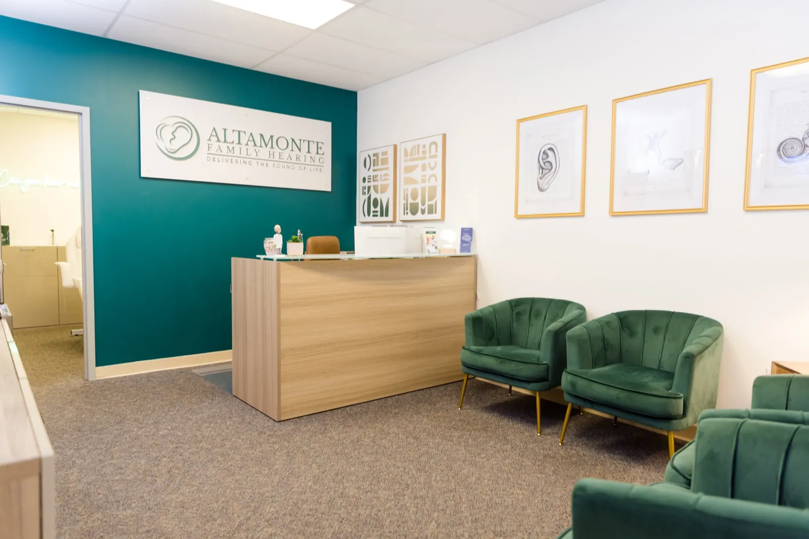 The waiting room at Altamonte Family Hearing: green armchairs and the front desk