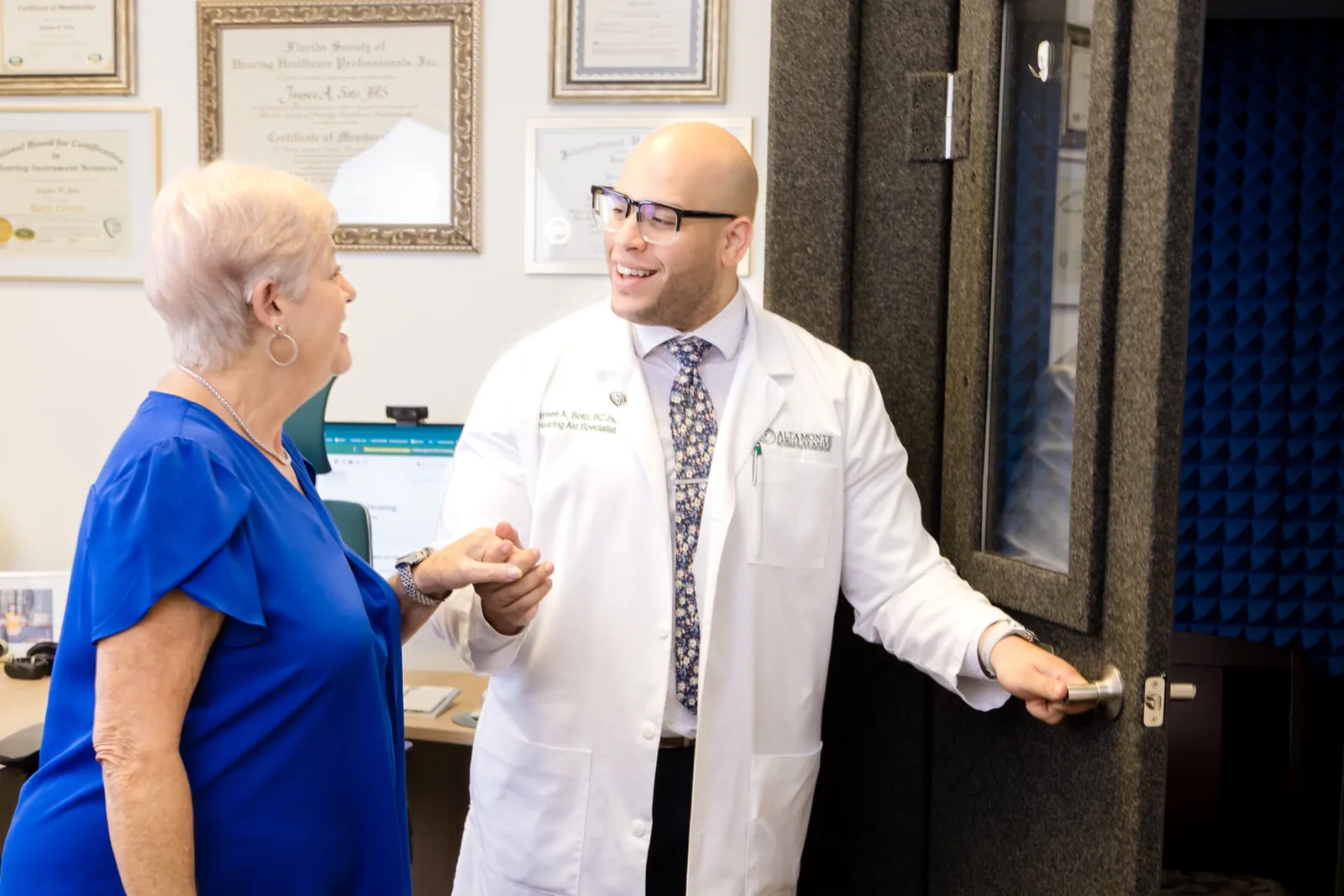 Jaysee shaking hands with a patient at the door